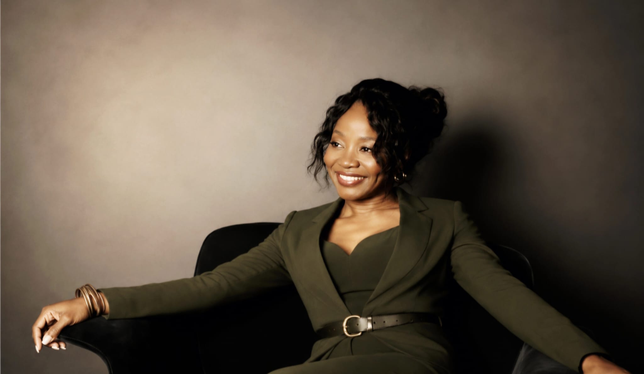 Shena Lee-Anthony seated in a relaxed professional pose — health recovery coach and burnout prevention specialist